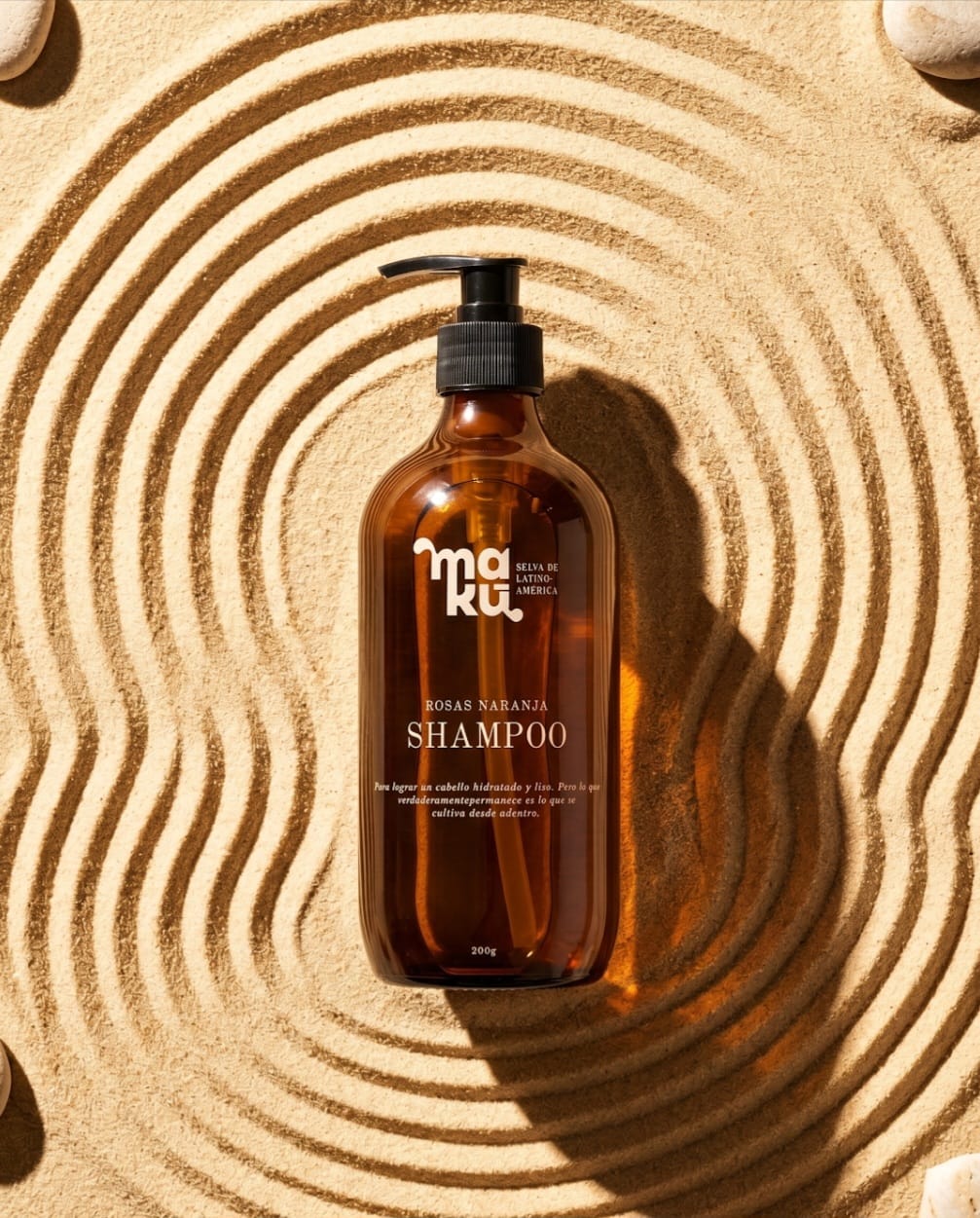 Maku shampoo bottle on sculpted sand